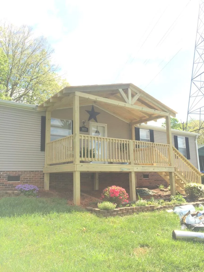 New gabled porch roof and deck railing added to a ranch home in Stromsburg
